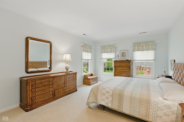carpeted bedroom with crown molding, baseboards, and visible vents