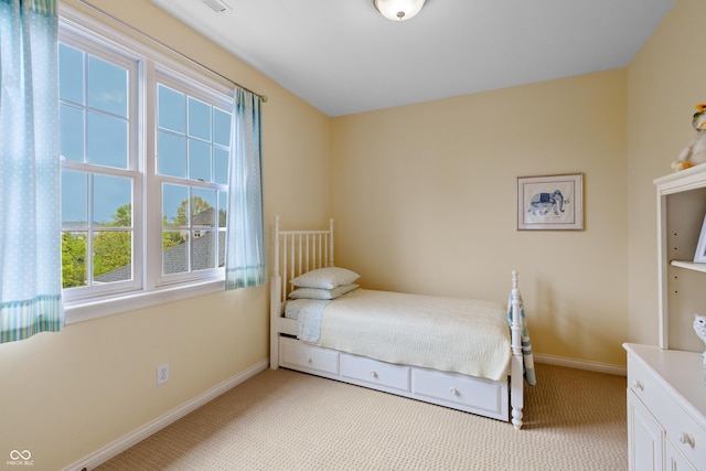 carpeted bedroom featuring baseboards