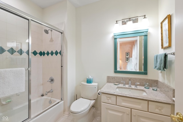 bathroom with toilet, bath / shower combo with glass door, and vanity