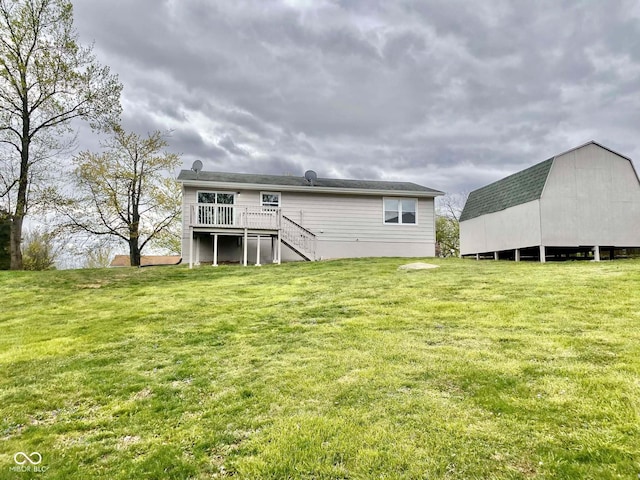 110 Renee Dr, Ellettsville, IN 47429 - back of house with stairs, a lawn, and a deck