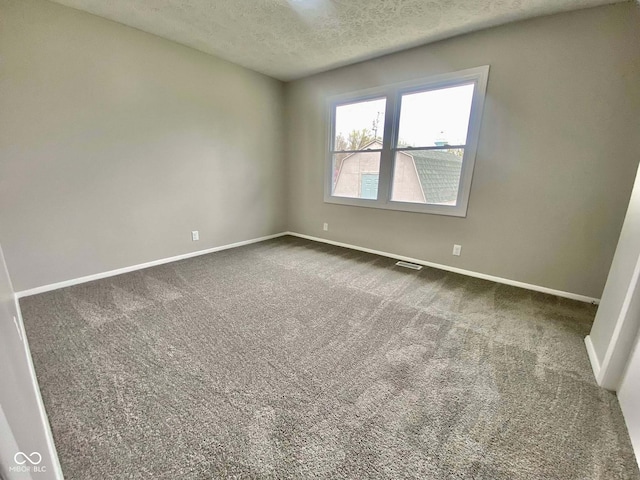 110 Renee Dr, Ellettsville, IN 47429 - spare room featuring a textured ceiling and dark carpet