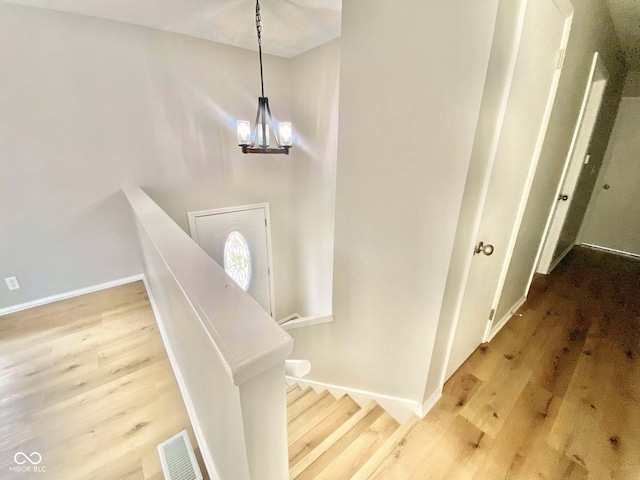110 Renee Dr, Ellettsville, IN 47429 - stairs featuring wood finished floors and a chandelier