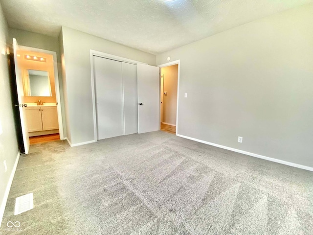 110 Renee Dr, Ellettsville, IN 47429 - unfurnished bedroom with carpet floors, a closet, and a textured ceiling