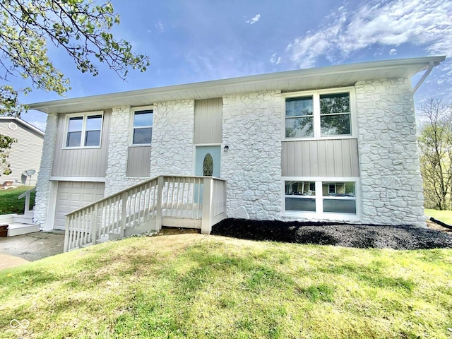 110 Renee Dr, Ellettsville, IN 47429 - view of front of property featuring stone siding, an attached garage, and a front lawn