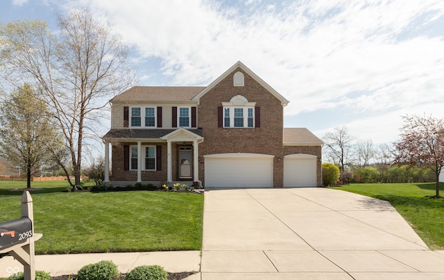 traditional home with a front yard, a garage, brick siding, concrete driveway, and an attached garage