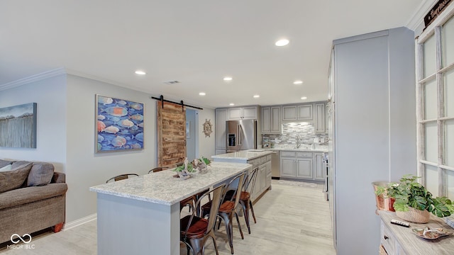 7003 Eagle Dr, Nineveh, IN 46164 - kitchen with stainless steel fridge with ice dispenser, a barn door, a center island, light wood finished floors, and gray cabinets