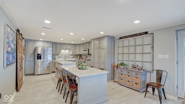 7003 Eagle Dr, Nineveh, IN 46164 - kitchen featuring stainless steel appliances, gray cabinets, ornamental molding, backsplash, and light wood-style flooring
