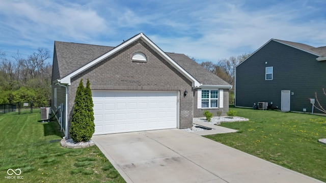 4323 Stubbington Ln, Indianapolis, IN 46239 - view of front of home featuring brick siding, cooling unit, a garage, and a front yard