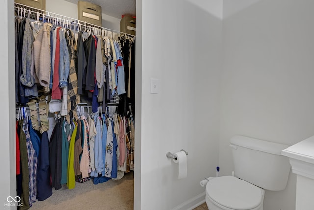 4323 Stubbington Ln, Indianapolis, IN 46239 - bathroom featuring toilet, baseboards, and a spacious closet