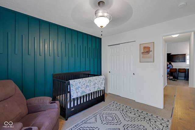 4323 Stubbington Ln, Indianapolis, IN 46239 - carpeted bedroom with a closet, baseboards, a crib, and ceiling fan