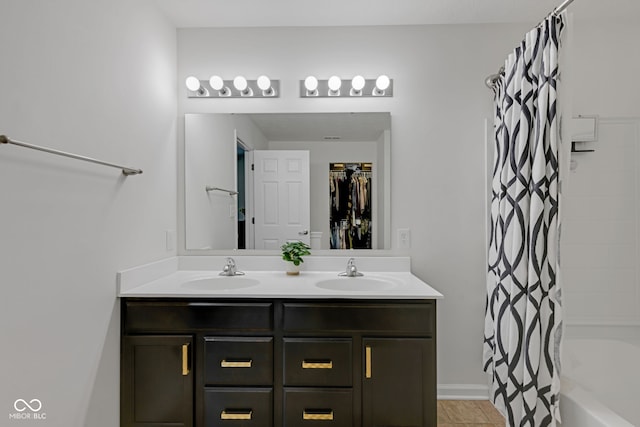 4323 Stubbington Ln, Indianapolis, IN 46239 - bathroom featuring double vanity, shower / tub combo with curtain, and a spacious closet