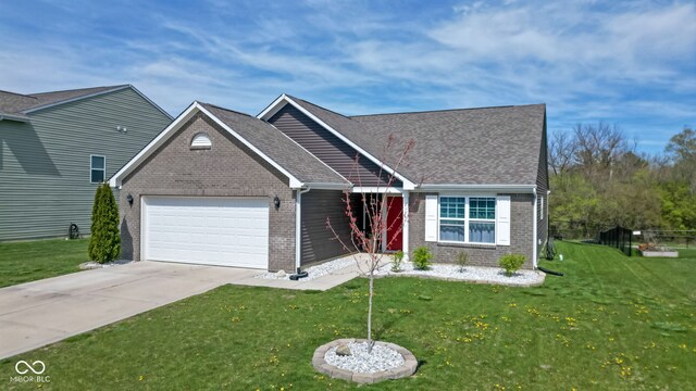 4323 Stubbington Ln, Indianapolis, IN 46239 - view of front facade with brick siding, an attached garage, a front lawn, concrete driveway, and a shingled roof