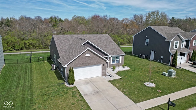 4323 Stubbington Ln, Indianapolis, IN 46239 - view of front facade with concrete driveway, brick siding, cooling unit, and an attached garage