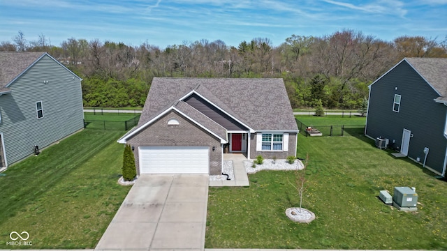 4323 Stubbington Ln, Indianapolis, IN 46239 - view of front of property featuring brick siding, an attached garage, cooling unit, concrete driveway, and roof with shingles