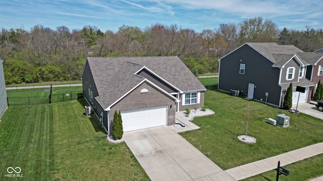 4323 Stubbington Ln, Indianapolis, IN 46239 - view of front of property featuring concrete driveway, brick siding, central AC unit, and a garage