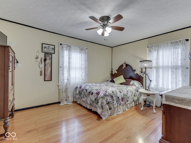 57 Worman St, Indianapolis, IN 46227 - bedroom with light wood finished floors, a ceiling fan, baseboards, and a textured ceiling