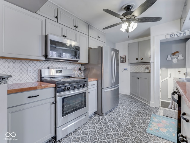 57 Worman St, Indianapolis, IN 46227 - kitchen with a ceiling fan, appliances with stainless steel finishes, and tasteful backsplash