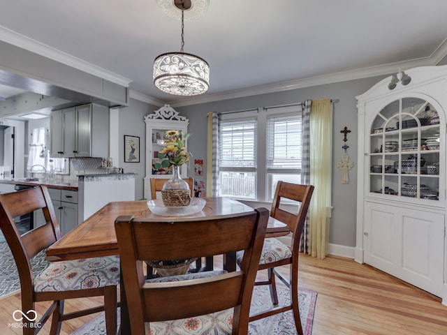 57 Worman St, Indianapolis, IN 46227 - dining space featuring light wood-style flooring, crown molding, baseboards, and an inviting chandelier