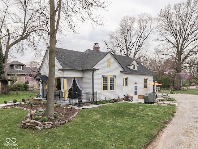 57 Worman St, Indianapolis, IN 46227 - back of property with driveway, a chimney, a lawn, a shingled roof, and a patio