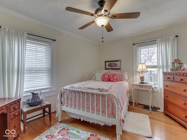 57 Worman St, Indianapolis, IN 46227 - bedroom featuring crown molding, a textured ceiling, and light wood-type flooring