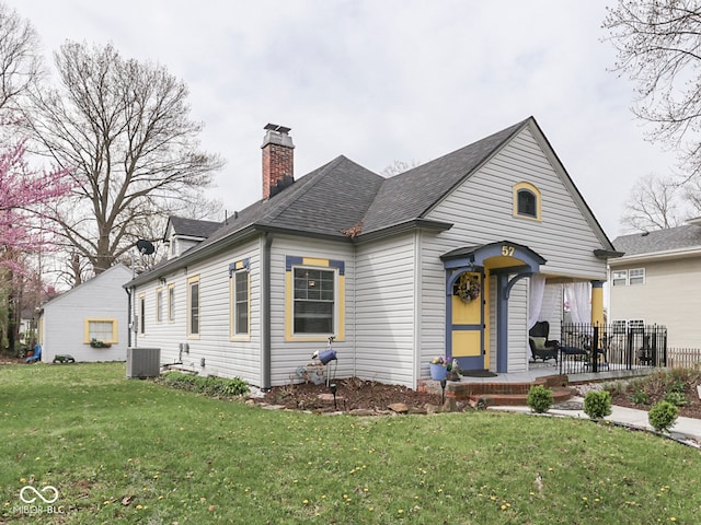 57 Worman St, Indianapolis, IN 46227 - bungalow-style house with a chimney, roof with shingles, central air condition unit, and a front yard