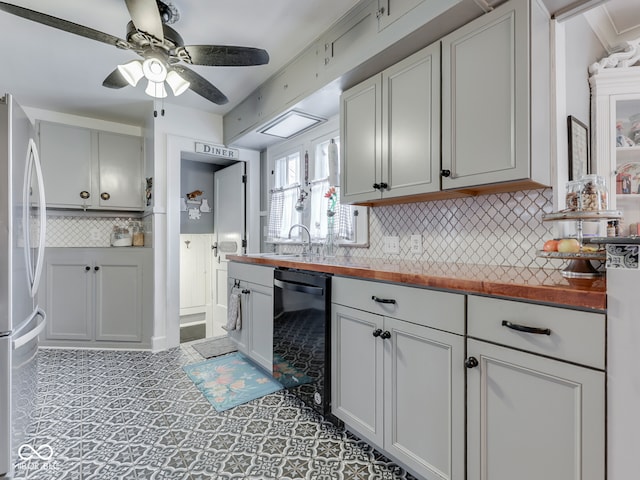 57 Worman St, Indianapolis, IN 46227 - kitchen with dishwasher, a sink, freestanding refrigerator, tasteful backsplash, and ceiling fan