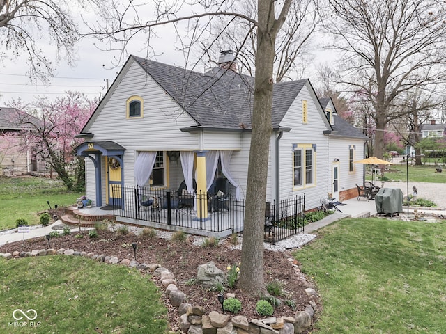 57 Worman St, Indianapolis, IN 46227 - rear view of property with a lawn, a chimney, a shingled roof, fence, and a patio