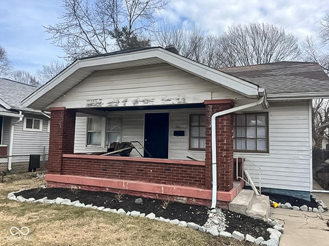 801 N Denny St, Indianapolis, IN 46201 - view of front of property featuring fence, a porch, and roof with shingles