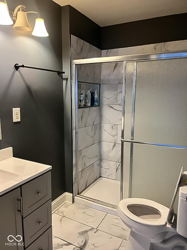801 N Denny St, Indianapolis, IN 46201 - full bathroom featuring a stall shower, vanity, marble finish floor, baseboards, and toilet