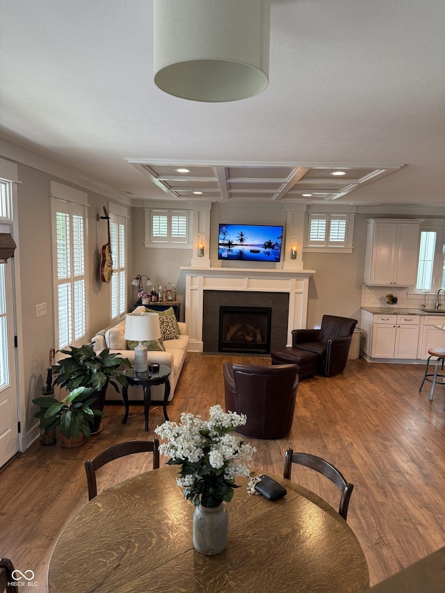 7638 Beekman Ter, Zionsville, IN 46077 - dining room with wood finished floors, plenty of natural light, a fireplace, recessed lighting, and coffered ceiling