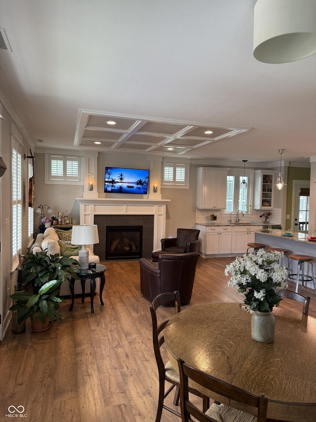 7638 Beekman Ter, Zionsville, IN 46077 - dining space featuring a tile fireplace, recessed lighting, wood finished floors, healthy amount of natural light, and ornamental molding