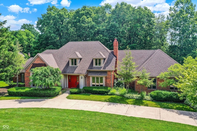 7545 Chablis Cir, Indianapolis, IN 46278 - view of front facade with brick siding, a front yard, and a chimney