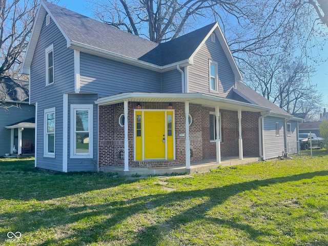 1001 N 14th St, Elwood, IN 46036 - view of front of property featuring brick siding, a front lawn, and covered porch