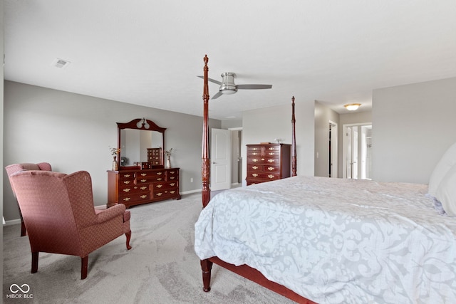 carpeted bedroom with visible vents, a ceiling fan, and baseboards