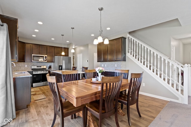 dining space featuring stairway, recessed lighting, and light wood finished floors