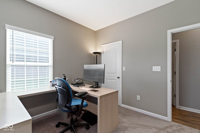 office area with baseboards and light carpet