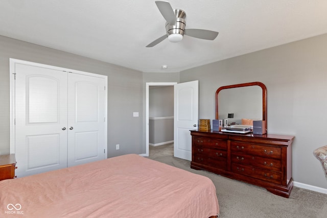 bedroom featuring a closet, a ceiling fan, carpet, and baseboards