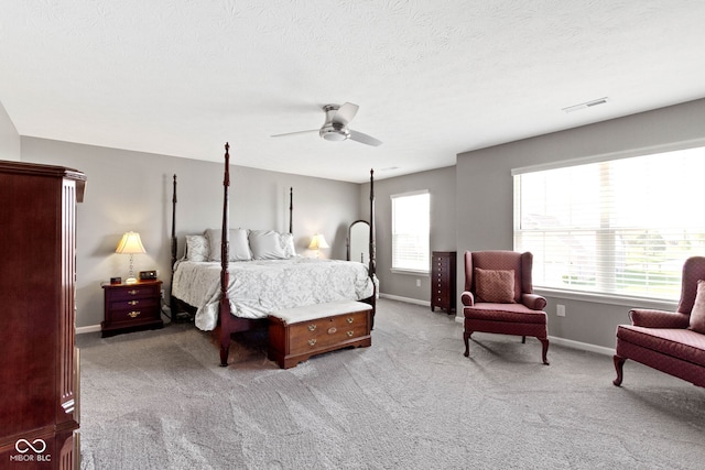 bedroom featuring carpet flooring, ceiling fan, a textured ceiling, baseboards, and visible vents