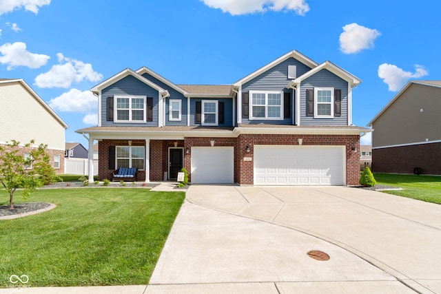 craftsman inspired home with brick siding, a garage, a front yard, and concrete driveway