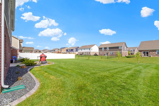 view of yard with fence, a residential view, and a patio area