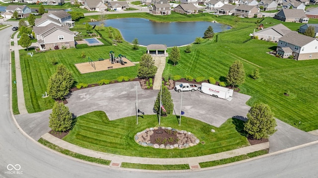birds eye view of property with a residential view and a water view