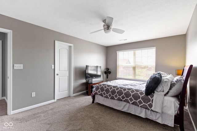 carpeted bedroom featuring baseboards, visible vents, and ceiling fan
