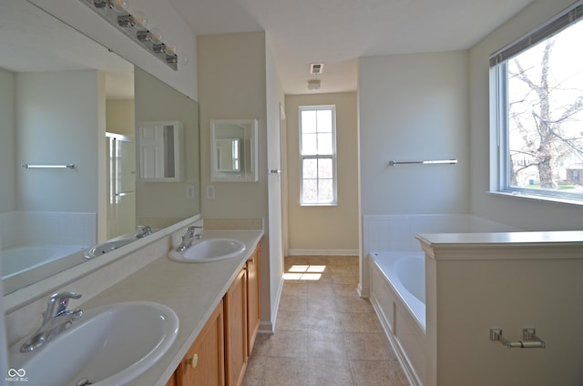 full bath featuring a garden tub, visible vents, a sink, and double vanity