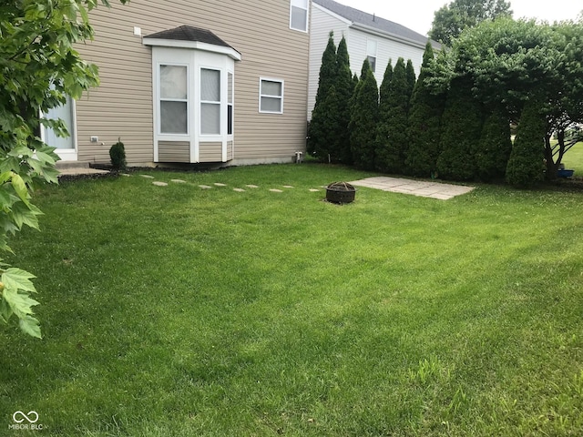 12326 River Valley Dr, Fishers, IN 46037 - view of green lawn with an outdoor fire pit