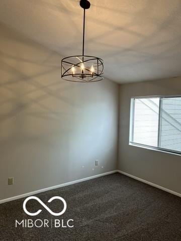 4311 Village Parkway Cir W Unit 6, Indianapolis, IN 46254 - empty room with baseboards, dark carpet, and a chandelier