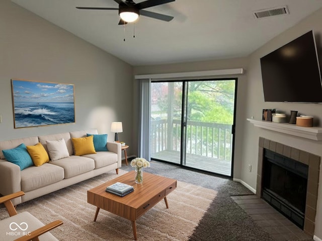 4311 Village Parkway Cir W Unit 6, Indianapolis, IN 46254 - living room with a ceiling fan, a tile fireplace, baseboards, lofted ceiling, and visible vents