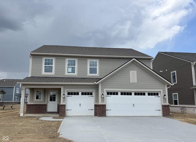 view of front of property with concrete driveway, brick siding, an attached garage, and a shingled roof