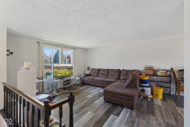 living area with wood finished floors and a textured ceiling