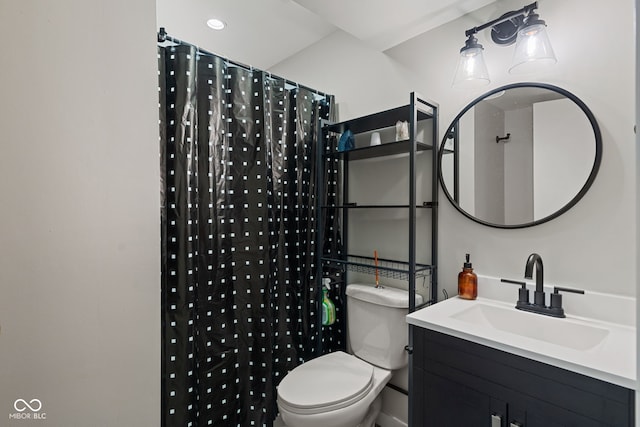 bathroom with toilet, vanity, and curtained shower