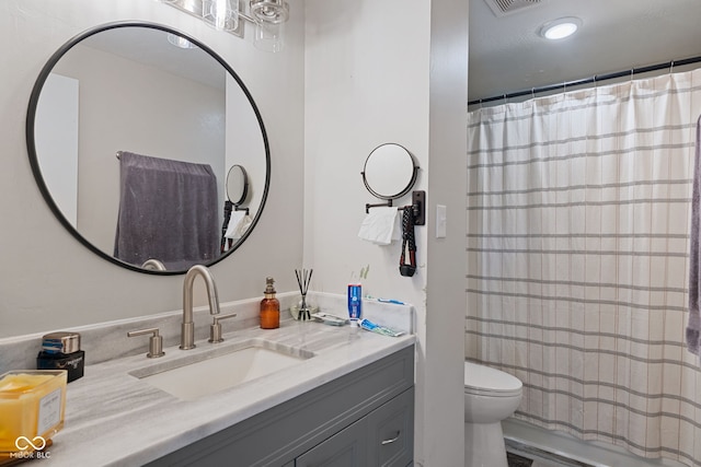 full bathroom with toilet and vanity
